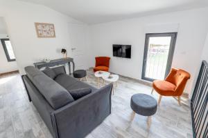 迪涅莱班Plaines-Provence Spa&Sauna的客厅配有沙发和桌椅