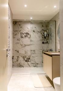 贝尔格莱德BW Aurora Lux Panorama的浴室配有带卫生间和水槽的大理石淋浴间。