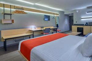 提华纳City Express by Marriott Tijuana Otay的配有一张床和一张书桌的酒店客房