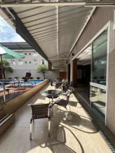 托莱多Nayru Hotel的一个带桌椅的庭院和一个游泳池