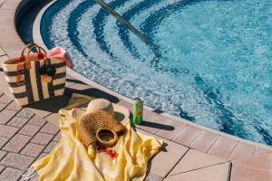 奥兰多Sonder at Vista Cay的游泳池旁的帽子和毛巾