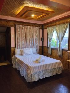 圣维森特Greenviews Resort & Restaurant Port Barton的卧室配有一张带白色床单和窗户的大床。