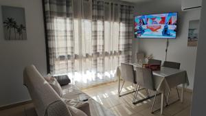 特尔德Casa Alisios的客厅配有桌椅和电视。