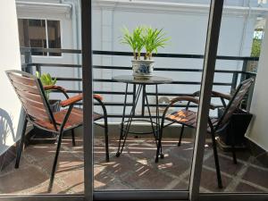 暹粒Andy's Place的阳台上的桌椅,种植了盆栽植物