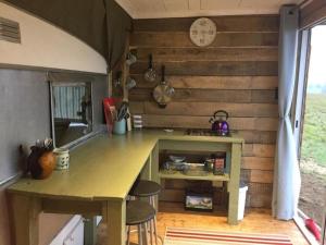 安德伯格Tin Can Glamping Caravan的一个小房子里的厨房,配有桌子