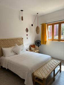 瓦哈卡市Santa Cecilia Hotel的卧室设有一张白色大床和一扇窗户。