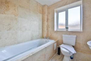 卡迪夫StayRight 3 Bed House with Private Parking的带浴缸、卫生间和盥洗盆的浴室