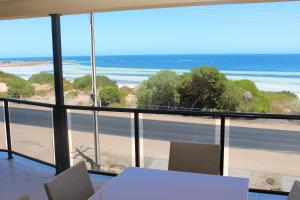 Port Hughes灯塔 - 海滨度假屋的配有桌椅并享有海滩景色的客房