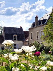 La MarcheChambre d'hôtes "Au bord de Loire"的一座房子,前面有一个种着鲜花的花园