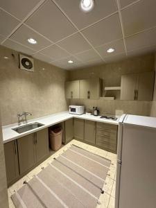 麦地那وحدة سكنية فاخرة 2 Luxury residential unit的一个带水槽和冰箱的空厨房