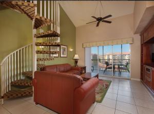 奥兰多Westgate town center resort的带沙发和楼梯间的客厅