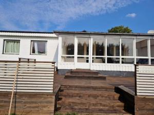 布罗斯Stort hus uthyres med utegård gräsmatta的前面设有木制甲板的房子