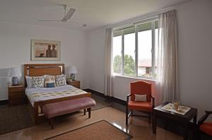 康提Fox Kandy的卧室配有床、椅子和窗户。