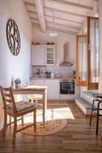塔瓦尔努泽Casa Cantagalli的厨房配有白色橱柜和桌椅