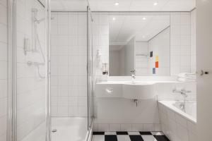 亨厄洛亨厄洛城市酒店的带淋浴和盥洗盆的白色浴室