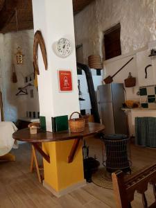 PedralbaLa casita del Horno的墙上有桌子和时钟的房间