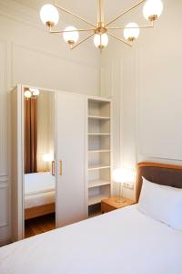 利耶帕亚Roze Center Apartments的卧室配有白色的床和衣柜。