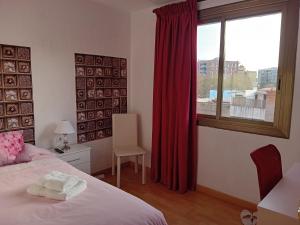 埃普拉特约布里加Apartamento compartido excelente ubicación的一间卧室配有床和红色窗帘的窗户