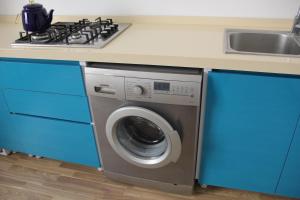 巴库Colour的厨房配有炉灶和洗衣机。