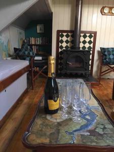 莫尔登Sailing Barge Reminder的一张桌子上摆放着一瓶葡萄酒和酒杯