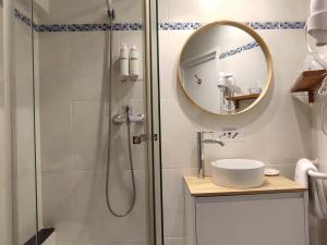 滨海托萨卡普多尔酒店的带淋浴、水槽和镜子的浴室