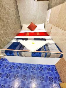 孟买HOTEL AMAAN PALACE的一个小房间,床位于房间性关节炎性关节炎性关节炎性关节炎的病房