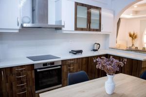 毕达哥利翁Spacious Apartment in the heart of Pythagorion的厨房配有木桌和花瓶