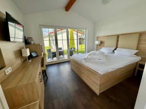 Seeburg哈弗兰德哈勒度假酒店的一间卧室设有一张大床和一个窗户。