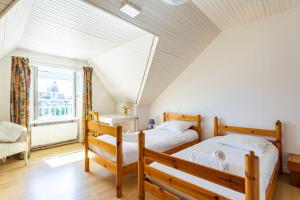 康卡勒Ker Roz - Belle maison 3 chambres- Proche Mer-Port的一间卧室设有两张床和窗户。
