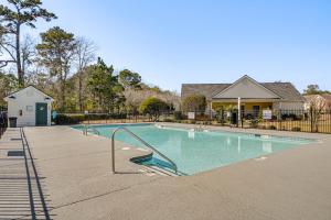 默特尔比奇Murrells Inlet Condo with Pool Access, Near Beach!的房屋前的游泳池