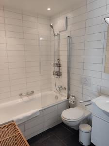 英格堡Superior Apartment的带浴缸、卫生间和盥洗盆的浴室