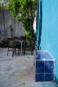 坎昆Casa Playa Hermosa的蓝色墙边的桌子和长椅