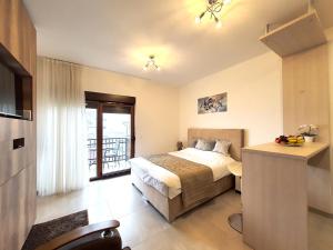 兹拉蒂博尔Zlatibor Hills Apartments Wellness & Spa的酒店客房设有一张床和一个阳台。