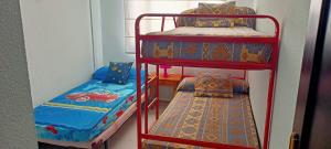 蓬塔翁布里亚Ático Punta Umbría的两张双层床和一张位于客房内的床铺