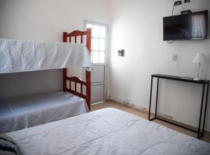 特尔马斯德里奥翁多GOa Hospedajes的一间卧室配有两张双层床和电视