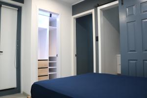 瓦努科Terraza house的一间卧室配有一张蓝色的床和一个衣柜