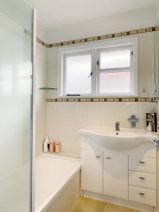 奥克兰Home in central Auckland的白色的浴室设有水槽和淋浴。