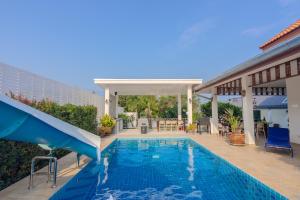 华欣Baan Kiang Lay Phu View Hua Hin Private Pool Villa บ้านเคียงเลภูวิว หัวหิน พูลวิลล่า กลางเมือง ใกล้หาดหัวหิน的一座房子里一个带滑梯的游泳池