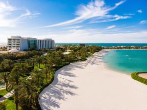 麦纳麦巴林丽思卡尔顿酒店的享有棕榈树海滩和大海的景色