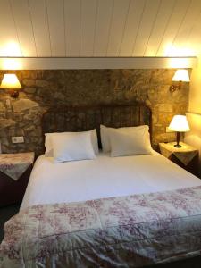 比拉德劳夏勒特克罗米娜酒店的一间卧室配有一张带两盏灯的大型白色床。