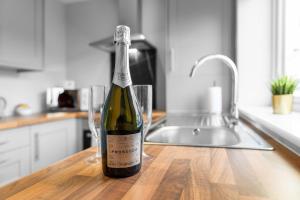 Stourbridge 2 Bedroom Apartment - Netflix & WIFI - Parking - 1CS的坐在厨房柜台上一瓶葡萄酒