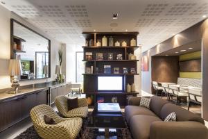 巴黎杜尔酒店的客厅配有两张沙发和一台电视