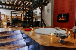 特镇L'Eden - Suite privative avec jacuzzi et sauna的一间带木台面及蜡烛浴缸的浴室