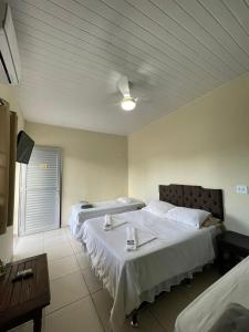 帕拉蒂CHILL INN HOSTEL & POUSADA CENTRO的酒店客房设有两张床和一张桌子。