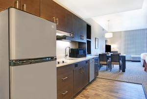 弗洛伍德TownePlace Suites by Marriott Jackson Airport/Flowood的带冰箱的厨房和用餐室
