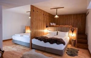坎普朗莫道尼斯HANUL BUCOVINEI的木墙客房的两张床