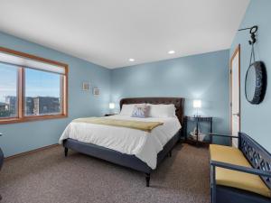 蒂拉穆克Shoreline Solace: Ocean View Townhouse Tillamook的蓝色的卧室设有床和窗户