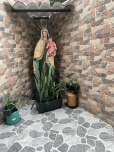 格拉纳达HOTEL PALMA ROJA的墙上有婴儿的女人的雕像