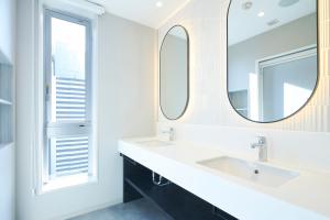 横滨Hotel Comento Yokohama Kannai的浴室设有2个水槽和镜子