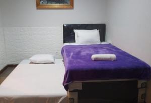Gadok 1Vila Princess. Vimalla hills 3br+1br Privatepool, minigolf, ayunan besar, bbq的一张带紫色毯子的床和两个枕头